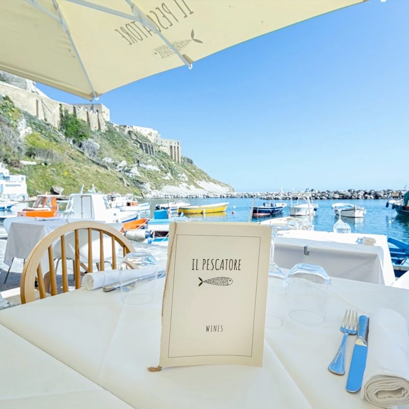 Table set at a seafront restaurant in the Gulf of Naples