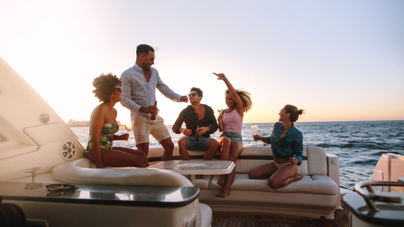 Guests on a private yacht at sunset in the Gulf of Naples
